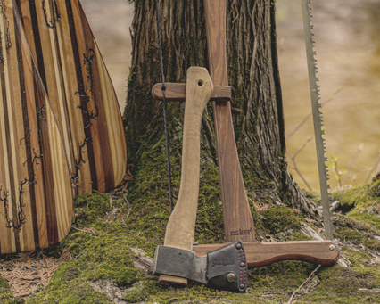 Esker axe and Esker Bucksaw resting against a tree in the forest