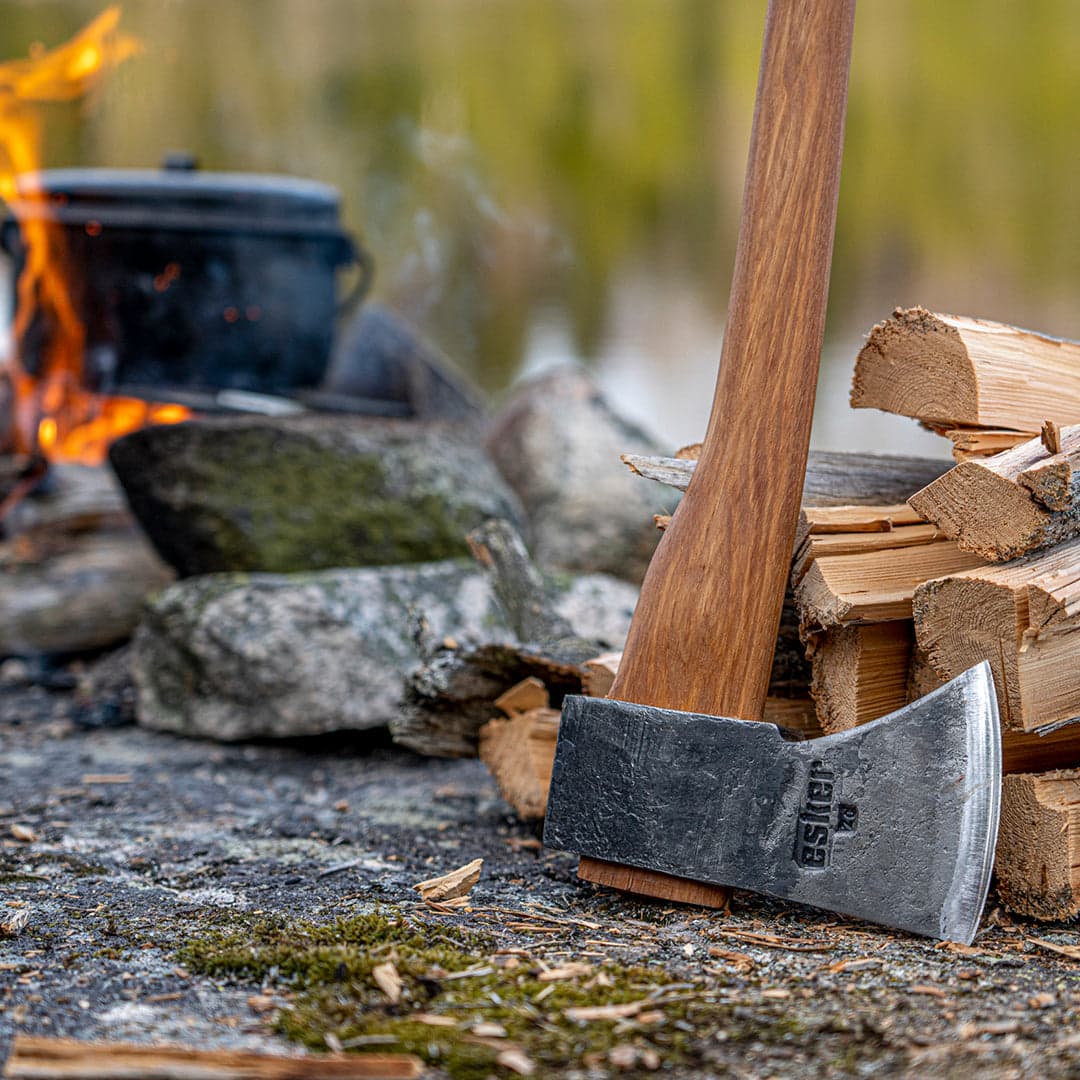 Esker Hatchet with firewood in front of a camp fire