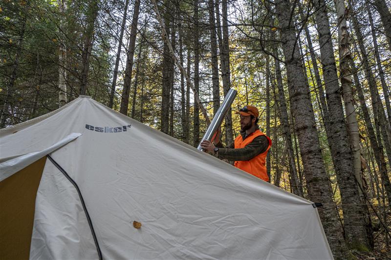 A man setting up Esker tent in Fall