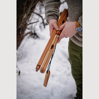 a person holding a folded esker bucksaw