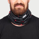 Man wearing a black neck gaiter with red maple leaf patterns and the esker logo on a gray background