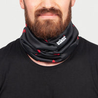 Man wearing a black neck gaiter with red maple leaf patterns and the esker logo on a gray background