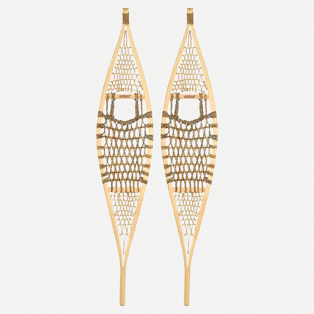 Pair of traditional snowshoes on a light grey background 
