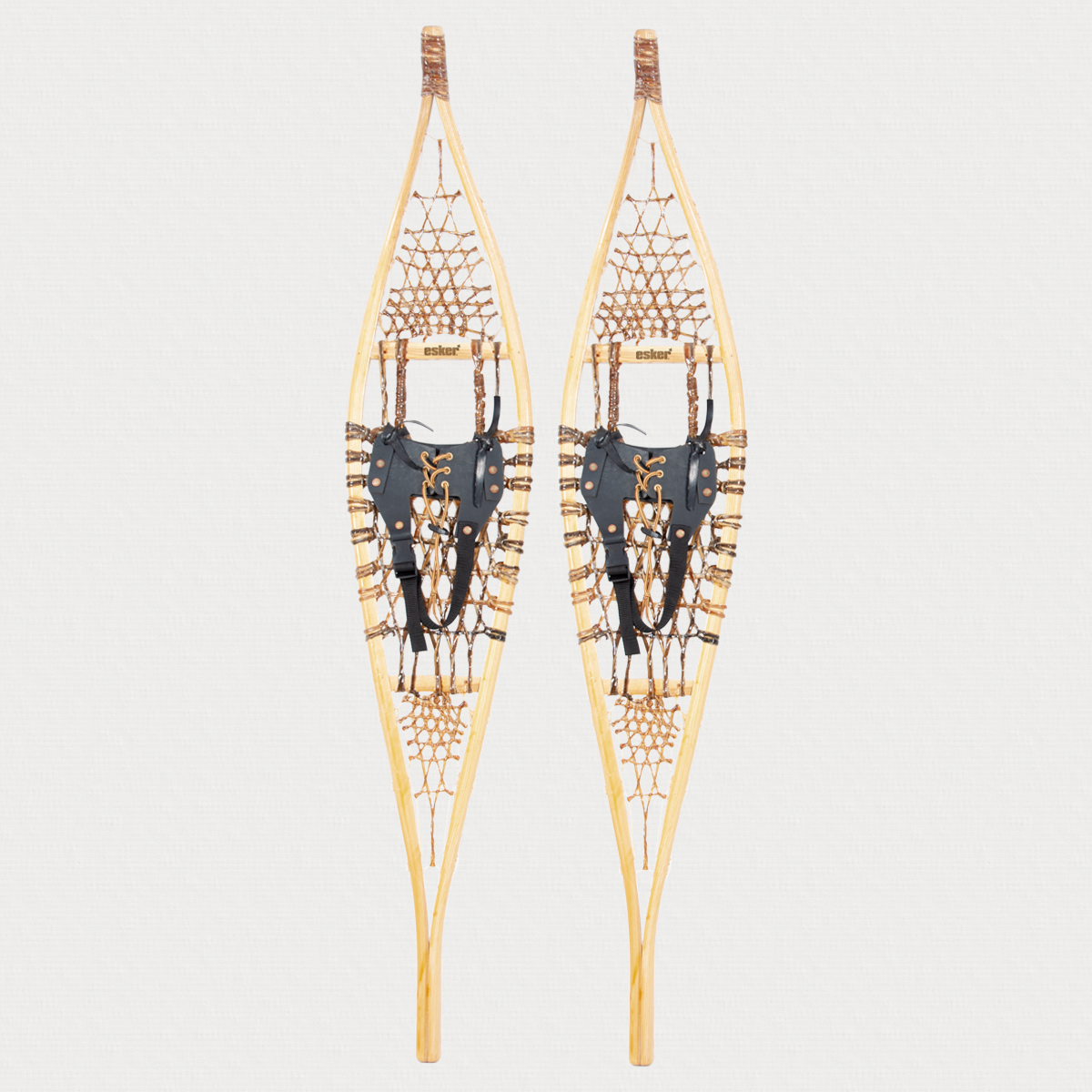 Pair of Traditional snowshoes on a light grey background 