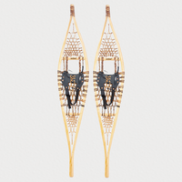 Pair of Traditional snowshoes on a light grey background 