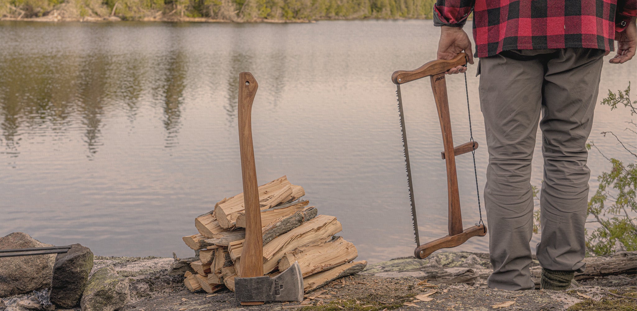 Esker Camp Axe and Bucksaw in a campsite