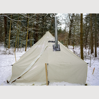 Esker tent with a chimney in a snowy forest